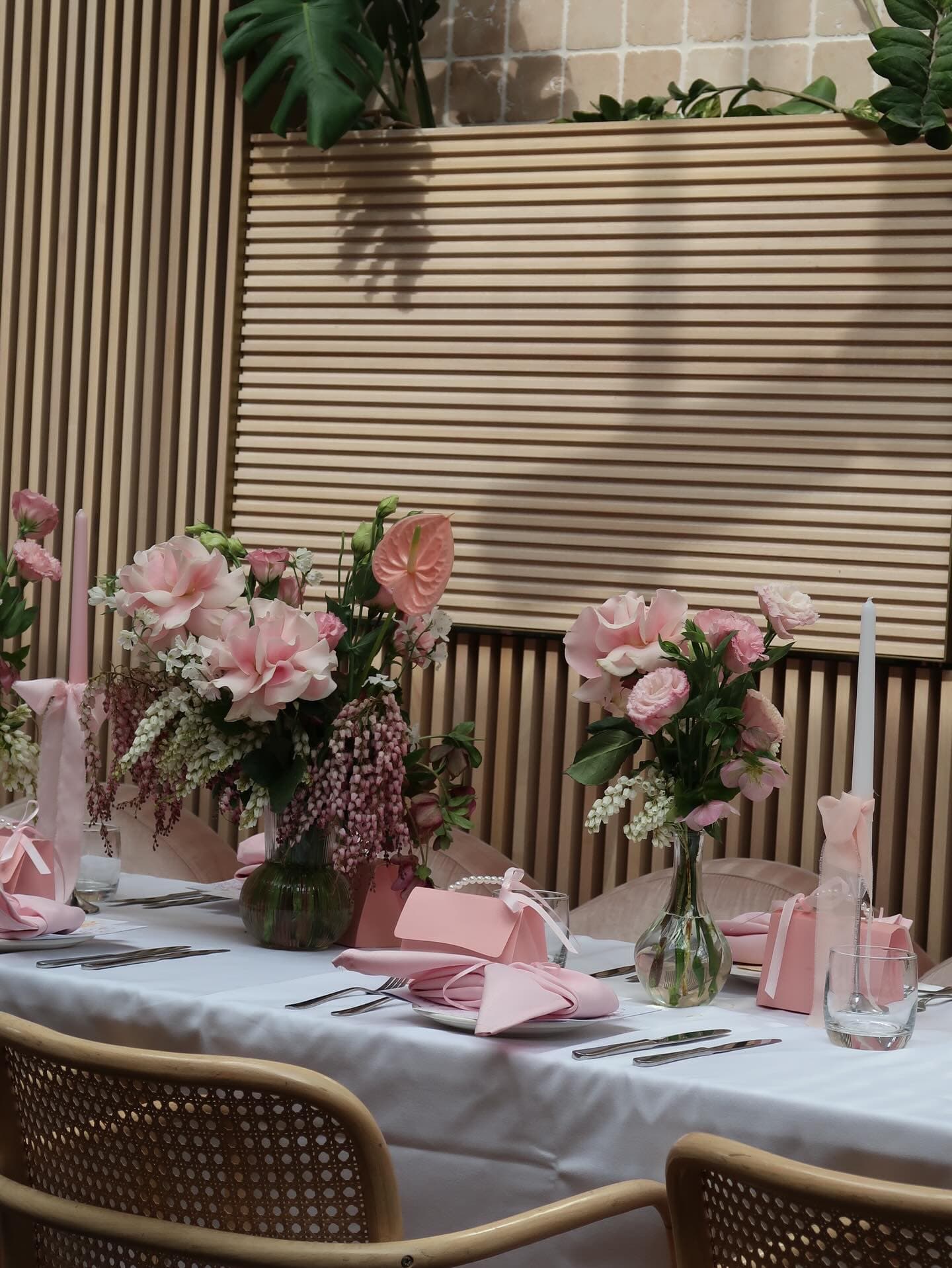 Detail of pink floral arrangement with rose and delicate blooms